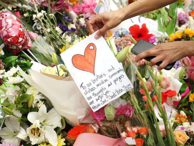 Flowers and messages are places on the steps of the Kilbirnie Mosque in Wellington. 