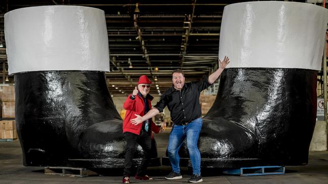 Businessman Lance Vater and TV personality Cosi Costello in front of Santa's big black boots Picture: Roy VanDerVegt