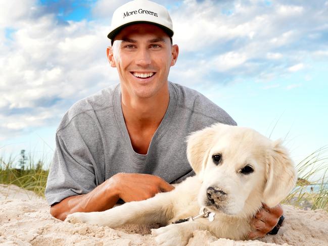 Crows recruit Isaac Cumming and his dog Nelson at Seacliff Beach. Picture: Dean Martin