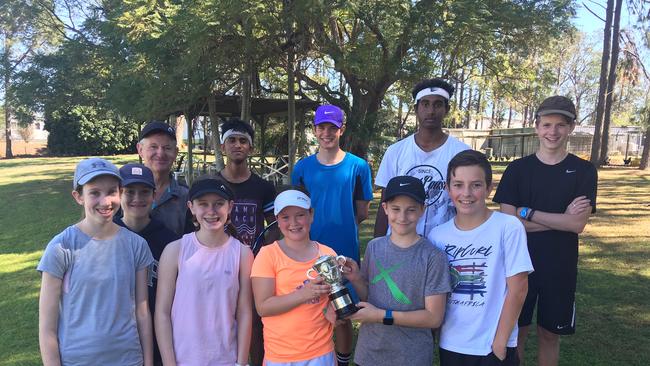 Ashleigh Barty's French Open trophy replica with some of the juniors at her spiritual home of the West Brisbane Tennis Centre last year.