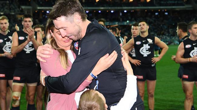 Dale Thomas of the Blues hugs his partner Hayley Robertson and nephew after his last game. Picture: Quinn Rooney/Getty Images.