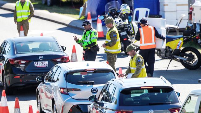 Police and the Army at the Queensland border on the Gold Coast Highway. The borders will be closed to five million people from the greater Sydney region from 1am on Saturday, August 1, 2020. Picture: NIGEL HALLETT