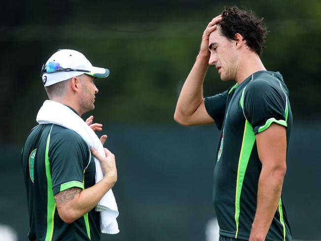 Michael Clarkehas a word with Mitchell Starc.