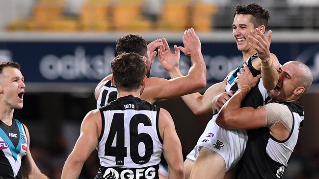 Connor Rozee of the Power (right) reacts after kicking a goal during the Round 3 AFL match agaisnt the Lions. Picture: AAP Image/Dave Hunt