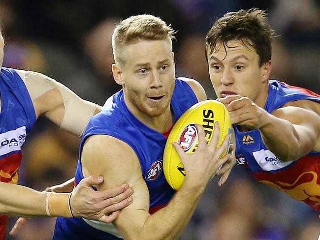 AFL Round 8. 12/05/2018.  Western Bulldogs v Brisbane Lions at Etihad Stadium. Western Bulldogs Lachie Hunter tries to break through the tacklers    . Pic: Michael Klein