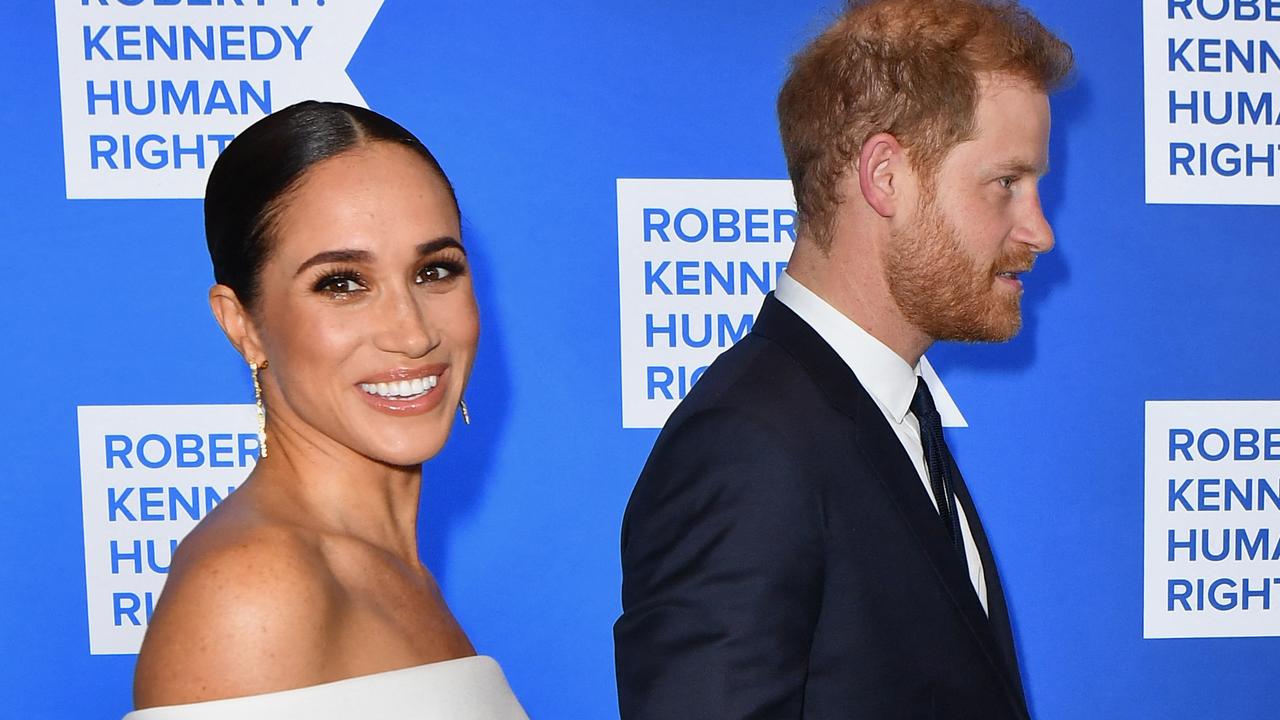 Meghan finished the sophisticated look with a sleek bun and soft smokey eye. Picture: Angela Weiss/AFP