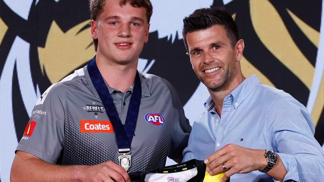 MELBOURNE, AUSTRALIA - NOVEMBER 20: The number one pick, Sam Lalor is presented his jumper by Trent Cotchin during the 2024 Telstra AFL Draft at Marvel Stadium on November 20, 2024 in Melbourne, Australia. (Photo by Michael Willson/AFL Photos via Getty Images)