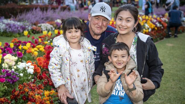 (From left) Avalyn Huang, Steve Munn, Jax Huang and Ava Huang in Queens Park during the Toowoomba Carnival of Flowers. Picture: Nev Madsen.