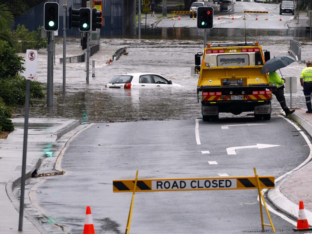 A car is stuck in flood waters in Toombul after heavy rain fell overnight in Brisbane. Picture: Tertius Pickard