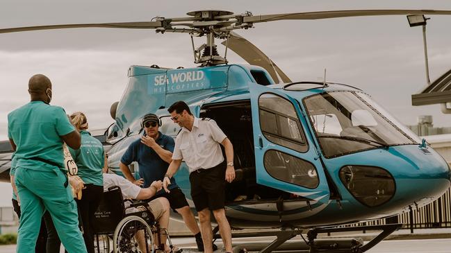 Sea World Helicopters pilot Michael James pictured with Chris, a man who Ambulance Wish Queensland was able to get on a Gold Coast Broadwater helicopter flight in October 2022.