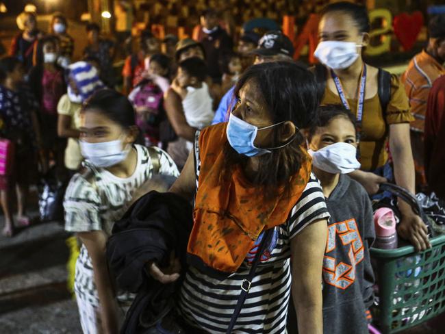 Residents arrive at local school after being evacuated. Picture: AP