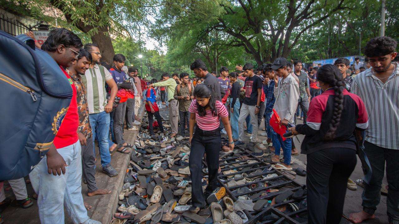 Fans of the Royal Challengers Bengaluru (RCB) look for footwear in a pile of discarded shoes and slippers after crowds got out of control on Wednesday. (Photo by Abhishek Chinnappa/Getty Images)