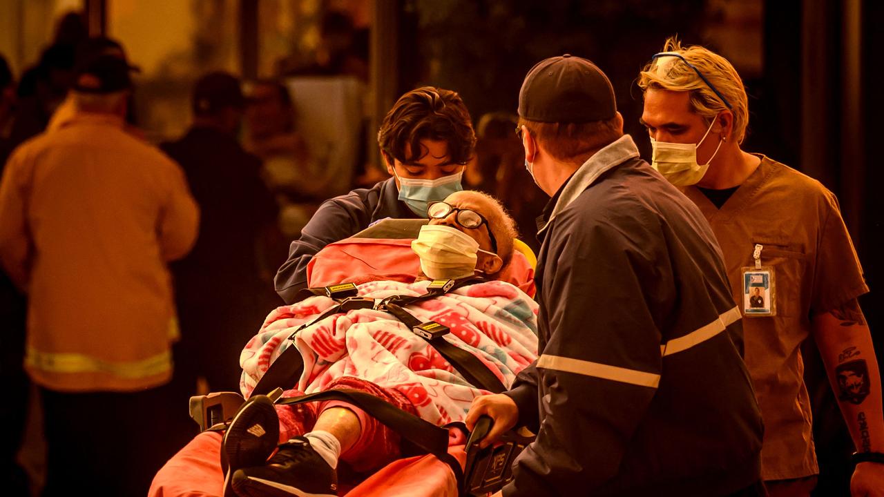 Patients are evacuated from the Brighton Care Center during the Eaton Fire in Pasadena, California. Photo by JOSH EDELSON / AFP