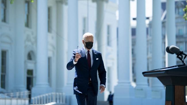 US President Joe Biden removes wears his mask as he prepares to speak about updated CDC guidance on masks for people who are fully vaccinated. Picture: AFP