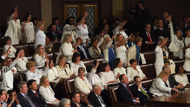 Democratic members of congress rise up as Mr Trump speaks about health care. Picture: AFP.