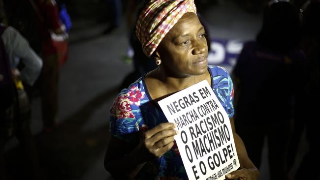 A woman holds a sign reading ‘Black women march against racism, male chauvinism and the coup’ during a protest against conservative Brazilian politicians – including Jair Bolsonaro.