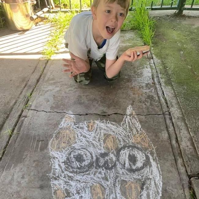 Ryan, Year 1 student, showing his creative chalk art of an owl during Education Week.