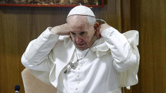 Pope Francis adjusts his papal cross as he arrives for the opening of the second day of a Vatican's conference on dealing with sex abuse by priests, at the Vatican, late last week. Picture: Giuseppe Lami/Pool Photo via AP