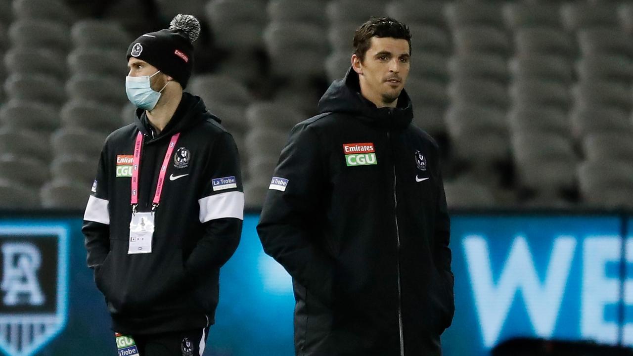 Scott Pendlebury watches on with injured teammate Jeremy Howe. Picture: Getty Images