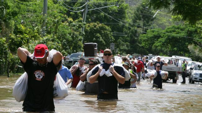 Out of nowhere, forty volunteers appeared on Beck St in Rosalie to haul sandbags across the flooded street.