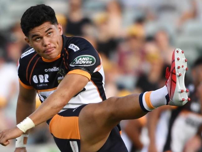 Lolesio kicks against the Reds. Picture: Getty Images