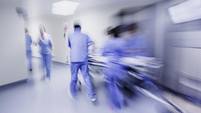 Doctors and nurses pulling hospital trolley. Picture: iStock