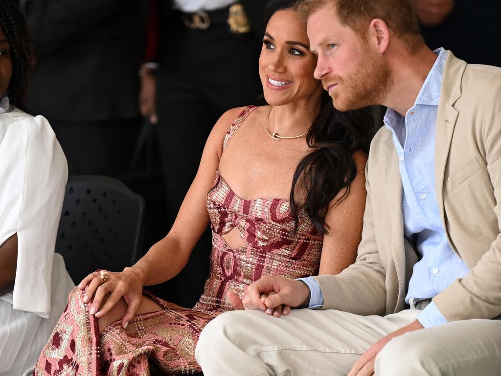 Prince Harry and Meghan Markle hold hands during their tour of Colombia. Picture: AFP