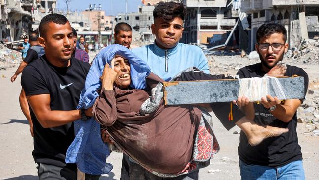 Men carry injured woman to be evacuated in the Jabalia camp in the northern Gaza Strip on Thursday. Picture: AFP