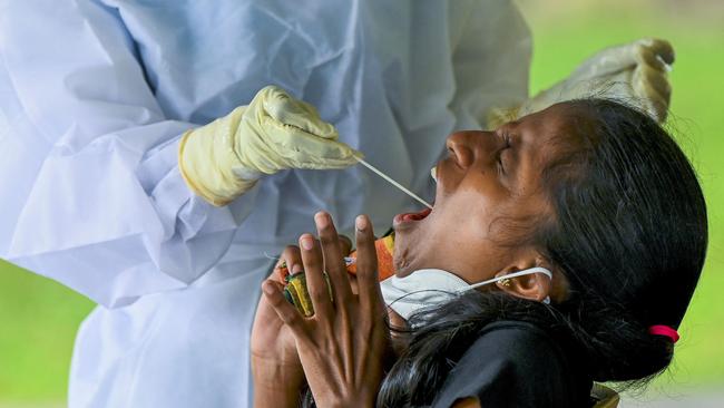 A health worker collects a swab sample for the Covid-19 coronavirus in Colombo. Picture: AFP