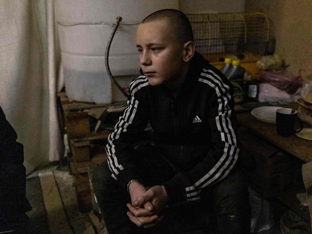 Gleb Petrov, 14-year-old, looks on as he sits with his family in a basement in the city of Bakhmut, eastern Ukraine. Picture: AFP