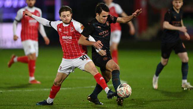 Cheltenham goalscorer Alfie May challenges Manchestr City’s Eric Garcia