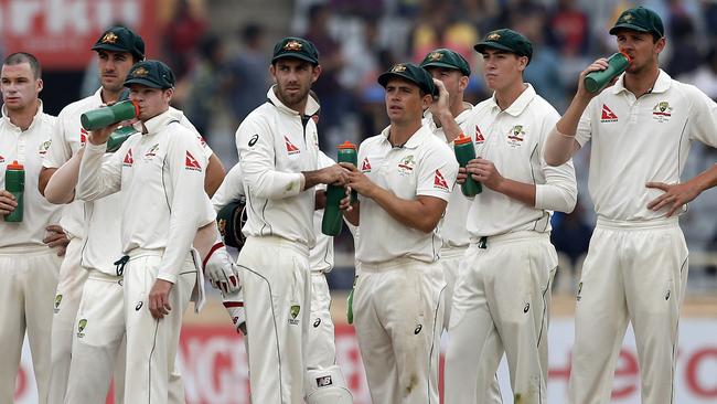 Australia’s fielders look on as Cheteshwar Pujara has a dismissal overturned on review.