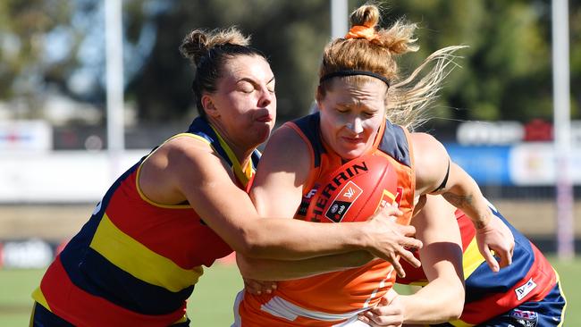 Giant Brittany Tully is wrapped up by Crow Ebony Marinoff on Sunday. Picture: AAP Image/David Mariuz