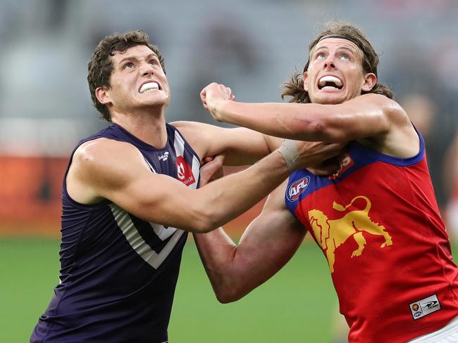 PERTH, AUSTRALIA - AUGUST 08: Lloyd Meek of the Dockers contests a ruck with Tom Fullarton of the Lions during the 2021 AFL Round 21 match between the Fremantle Dockers and the Brisbane Lions at Optus Stadium on August 8, 2021 in Perth, Australia. (Photo by Will Russell/AFL Photos via Getty Images)