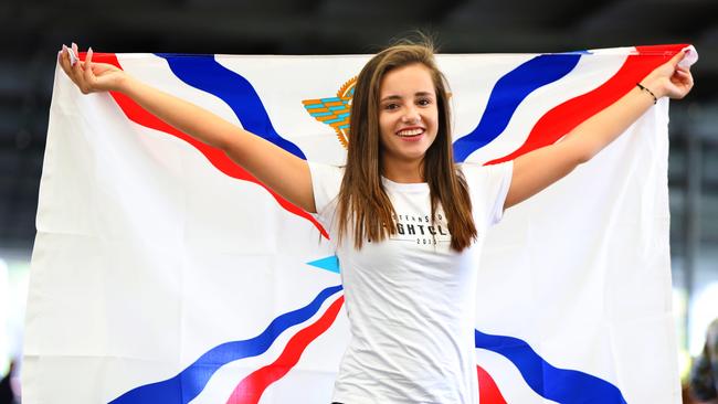 Tamar Kivarkis holds the Assyrian flag at the Assyrian New Year Festival. (AAP Image / Angelo Velardo)