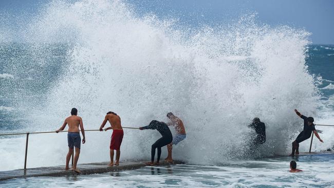 Swimmers brave huge waves at Bronte baths after days of wild storms lashed Sydney. Picture by Max Mason-Hubers