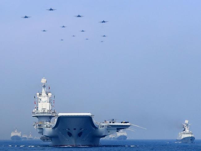 Chinese warships and fighter jets take part in a military display in the South China Sea in April. Picture: Xinhua