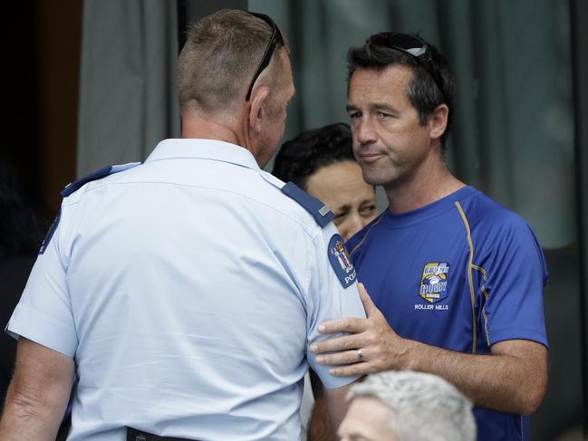 Mark Inman, right, brother of volcano victim Hayden Marshall-Inman talks to a police officer following a meeting in Whakatane, New Zealand. Picture: AP