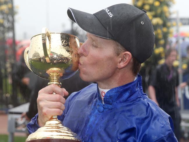 Kerrin McEvoy kisses the Melbourne Cup trophy after his victory in the famous race.