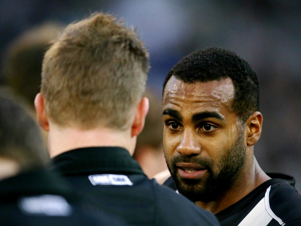 Nathan Buckley and Heritier Lumumba in a huddle.