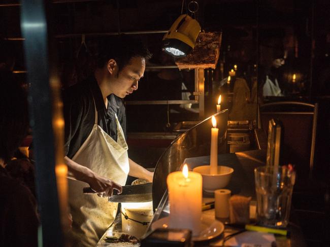 This Chinatown stall-holder ab-libbed to continue to cook through the power black-out. Picture: Joshua Turko