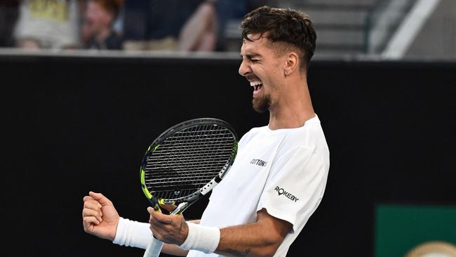 Australia's Thanasi Kokkinakis celebrates after beating Russia's Roman Safiullin in their men's singles match on day two of the Australian Open tennis tournament in Melbourne on January 13, 2025. (Photo by Paul Crock / AFP) / -- IMAGE RESTRICTED TO EDITORIAL USE - STRICTLY NO COMMERCIAL USE --