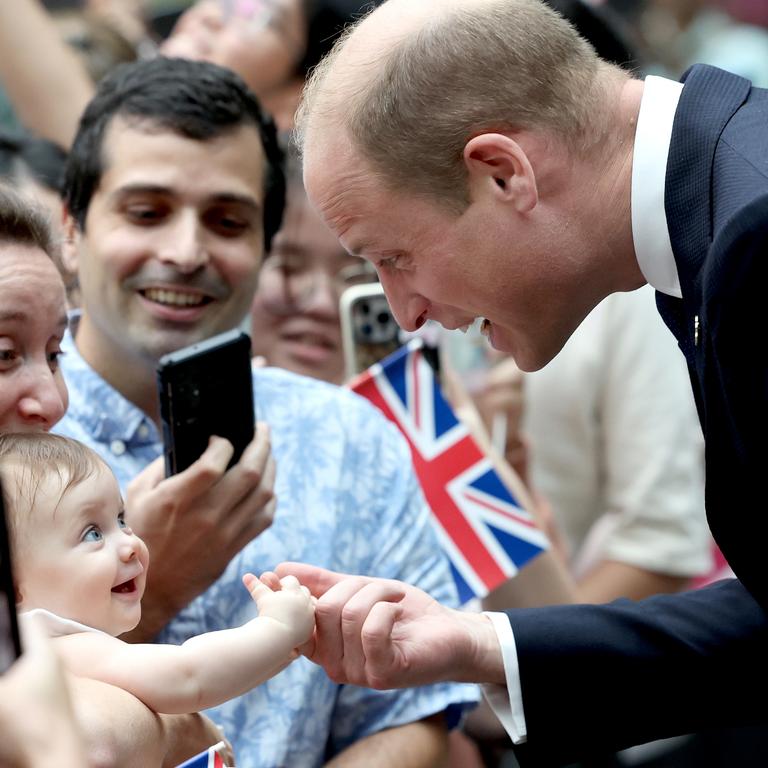 8-month-old Albane Costa holds the finger of Prince William during his visit to Singapore. Picture: Chris Jackson/Getty Images