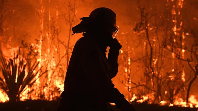 NSW Rural Fire Service crews protect properties as approaches Mangrove Mountain north of Sydney on December 5.