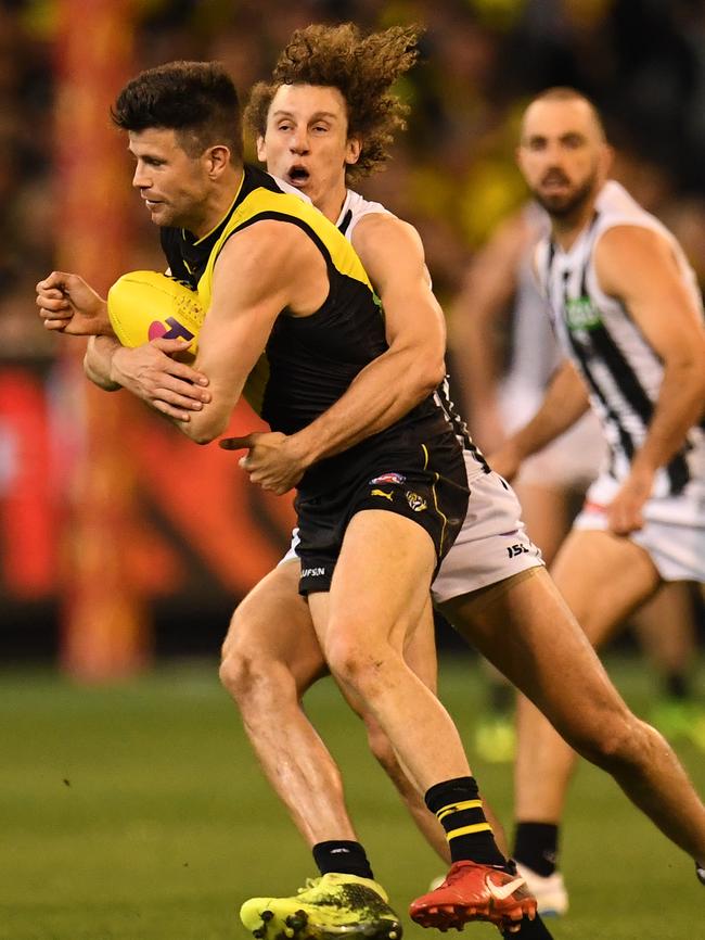 Collingwood’s Chris Mayne wraps up Trent Cotchin. Picture: AAP Image/Julian Smith