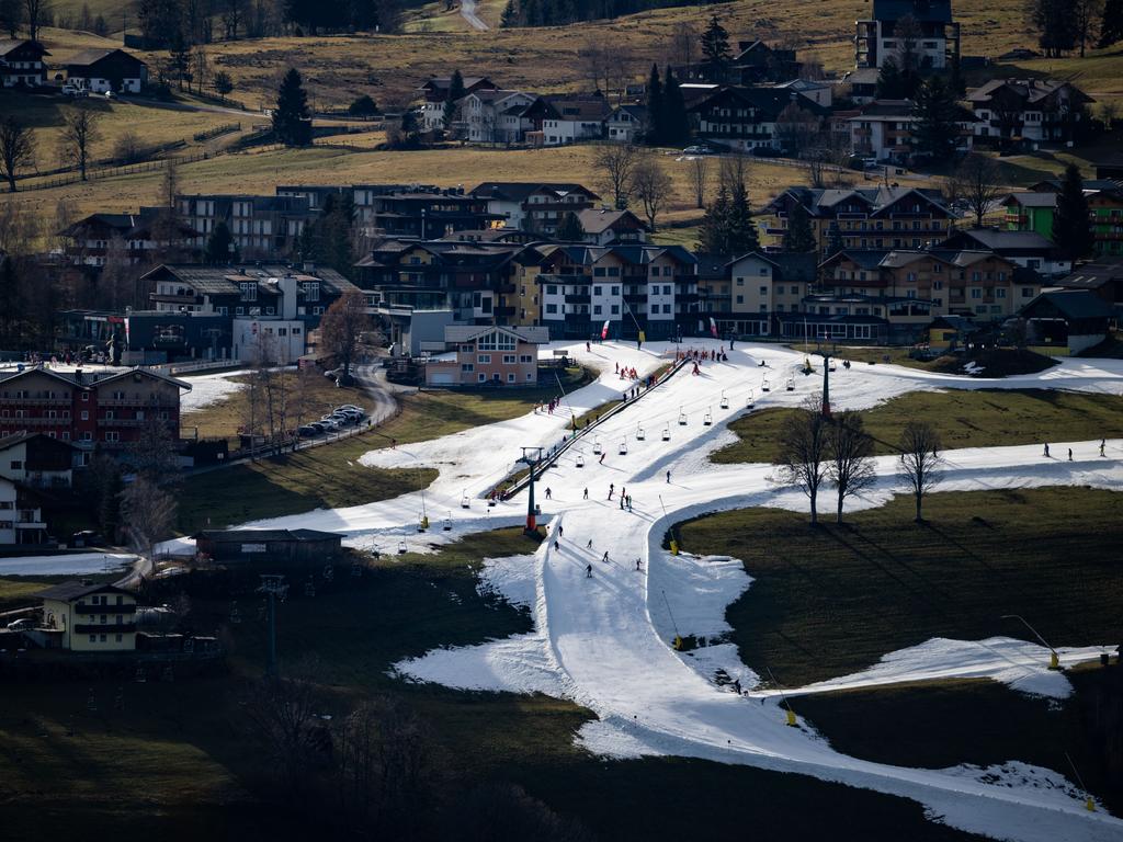 Alpine ski resorts faced an unseasonably warm January that brought record temperatures to many parts of Europe as skiers descended the slopes covered in artificial snow as grass covers the surrounding areas. Picture: Daniel Kopatsch/Getty Images