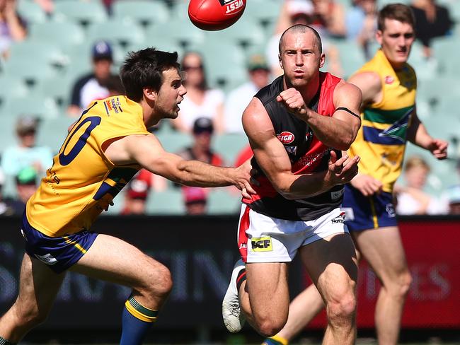 SANFL - Grand Final - Woodville-West Torrens Eagles v West Adelaide at Adelaide Oval. Jason Porplyzia gets his hand pass away from Christopher Hall. Photo Sarah Reed.