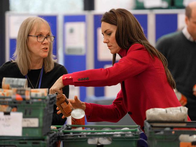 The couple helped package up food. Picture: AFP