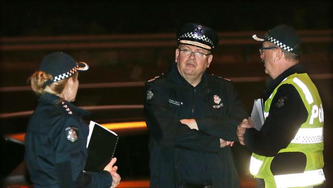 Victoria Police Chief Commissioner Graham Ashton (centre) at the scene last night.