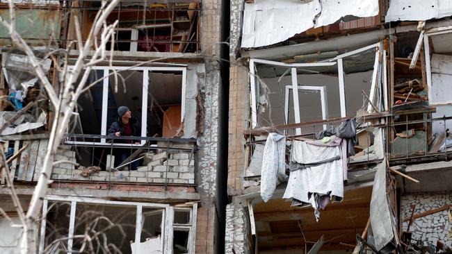 A resident looks out of the destroyed front of a room in a multistorey building that was badly damaged as a result of Russian missile explosion after it was shot down over the city by Ukrainian air defence. Picture: Anatolii Stepanov / AFP